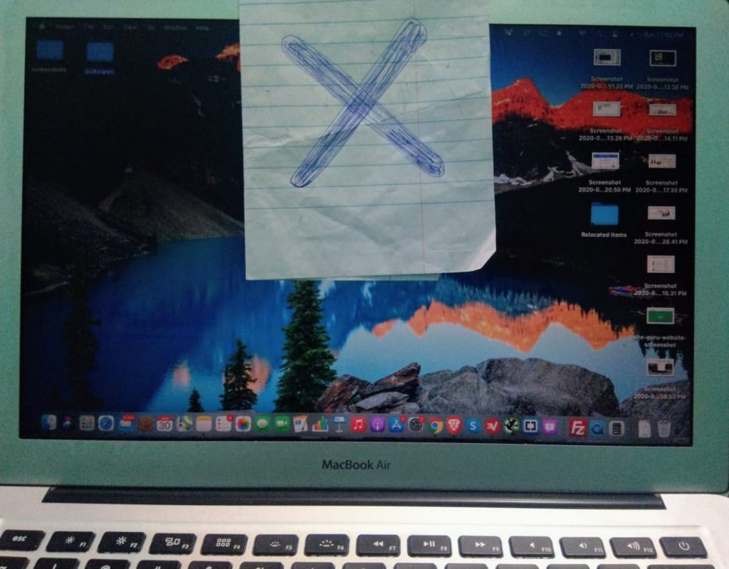 macbook air camera cover with paper marked cross on it